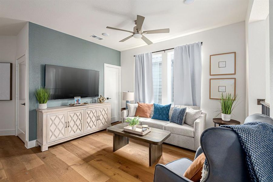 Living area featuring wood-type flooring, ceiling fan, and recessed lighting
