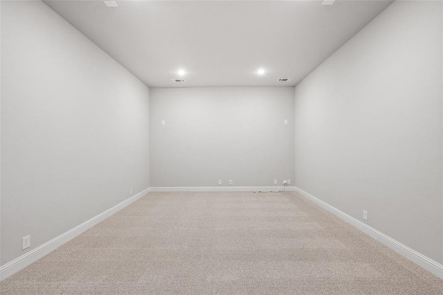 Empty room featuring light colored carpet and recessed lighting