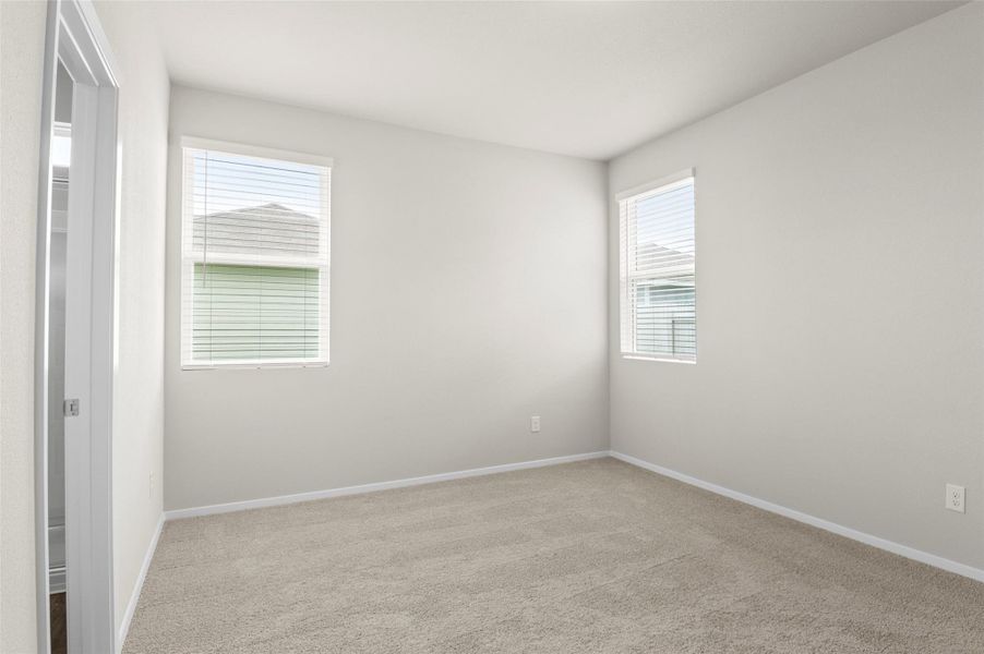Carpeted spare room with baseboards