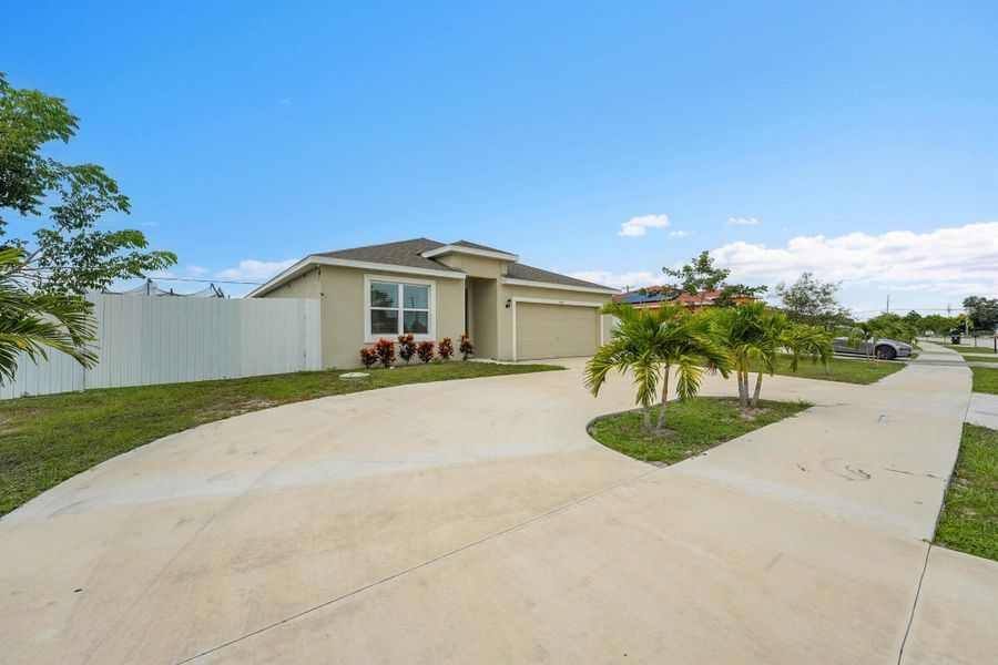 Front exterior of a new home in , Port St. Lucie, FL, highlighting curb appeal (Image 23).