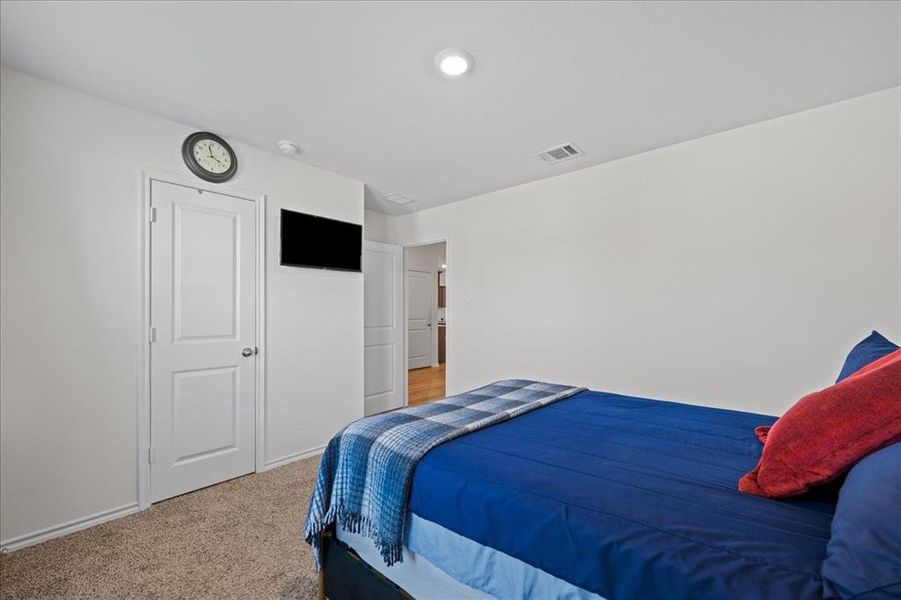 Carpeted bedroom with baseboards Carpeted bedroom with baseboards