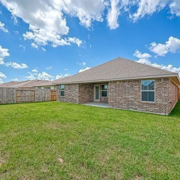 Front exterior of a new home in Kiber Reserve, Angleton, TX, highlighting curb appeal (Image 1).