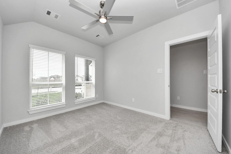 Generously sized secondary bedrooms featuring spacious closets, soft and inviting carpeting underfoot, large windows allowing plenty of natural light, and the added touch of privacy blinds for your personal retreat.