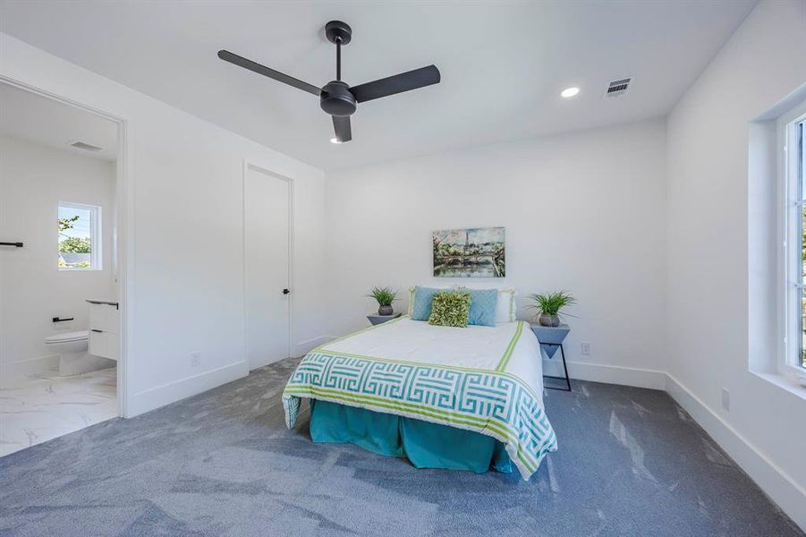 Carpeted bedroom with a ceiling fan and recessed lighting Carpeted bedroom with a ceiling fan and recessed lighting