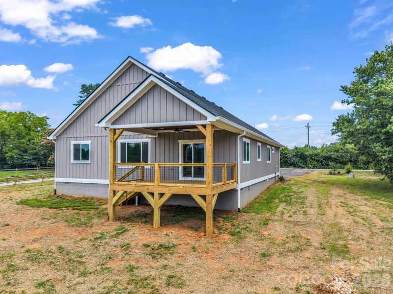View of the back of the home, covered rear porch with fan, great entertainment floor plan and useable flat outdoor space View of the back of the home, covered rear porch with fan, great entertainment floor plan and useable flat outdoor space