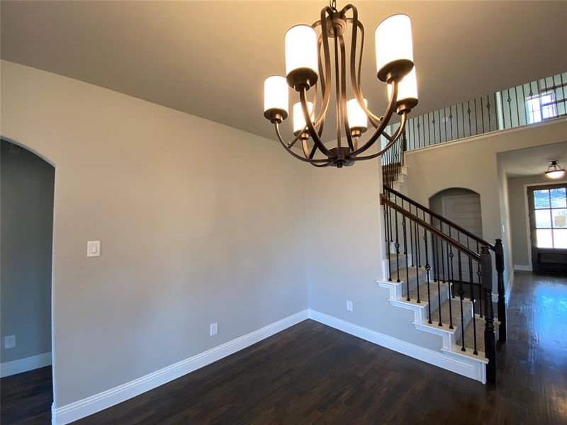 Open diining area with ORB chandelier has plenty of room for table to expand for special occasions