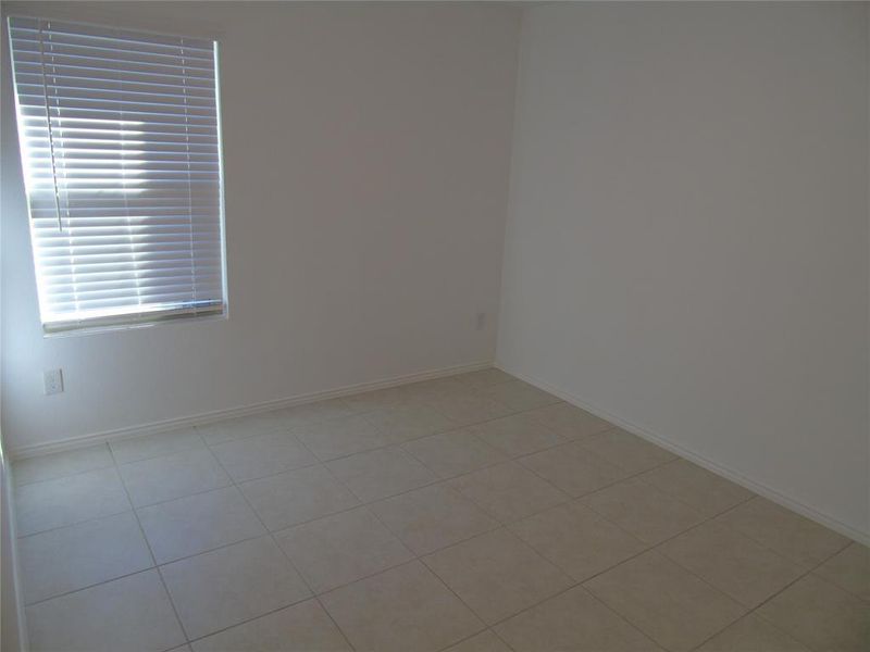 Empty room featuring light tile patterned floors