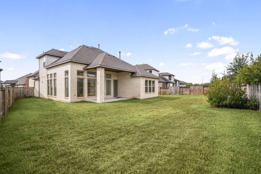 Even from the back this home is stunning. All four sides of the home are bricked!