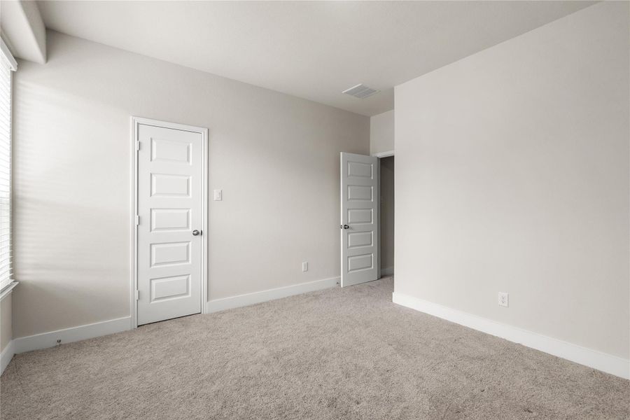 In addition to its versatile layout, the bedroom includes a walk-in closet, providing valuable storage space that helps keep the room organized and clutter-free.