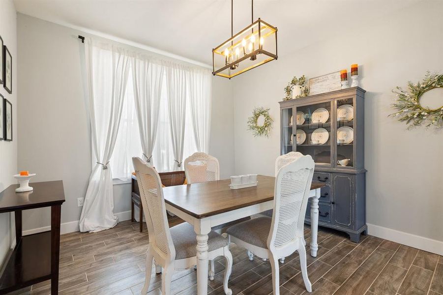 Dining area featuring a notable chandelier and dark hardwood / wood-style floors