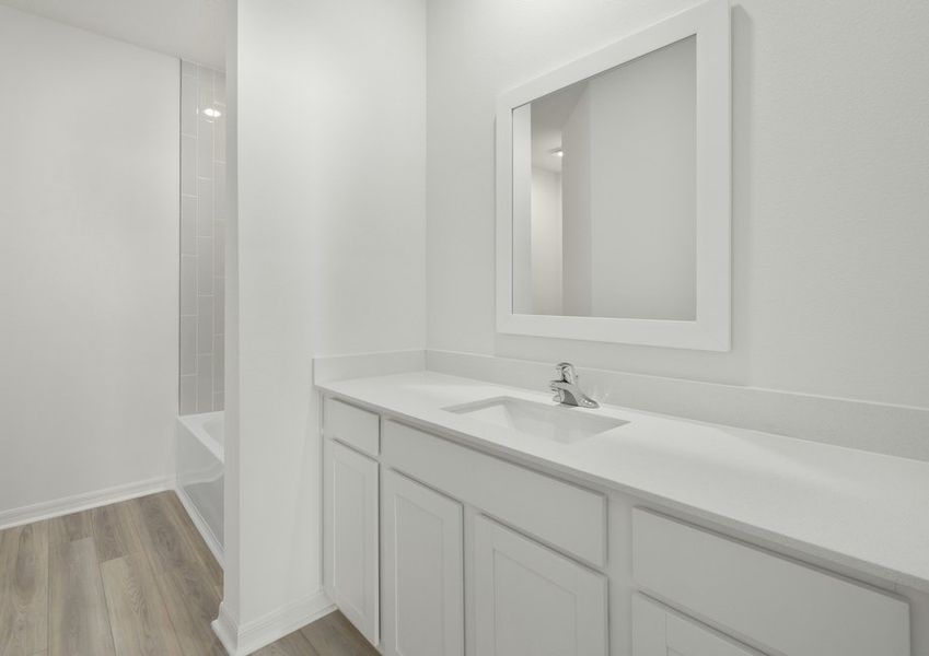Vanity in the master bathroom and a framed mirror