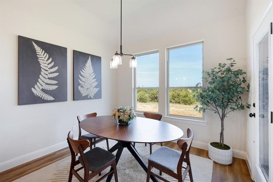 Dining room featuring a notable chandelier and hardwood / wood-style floors