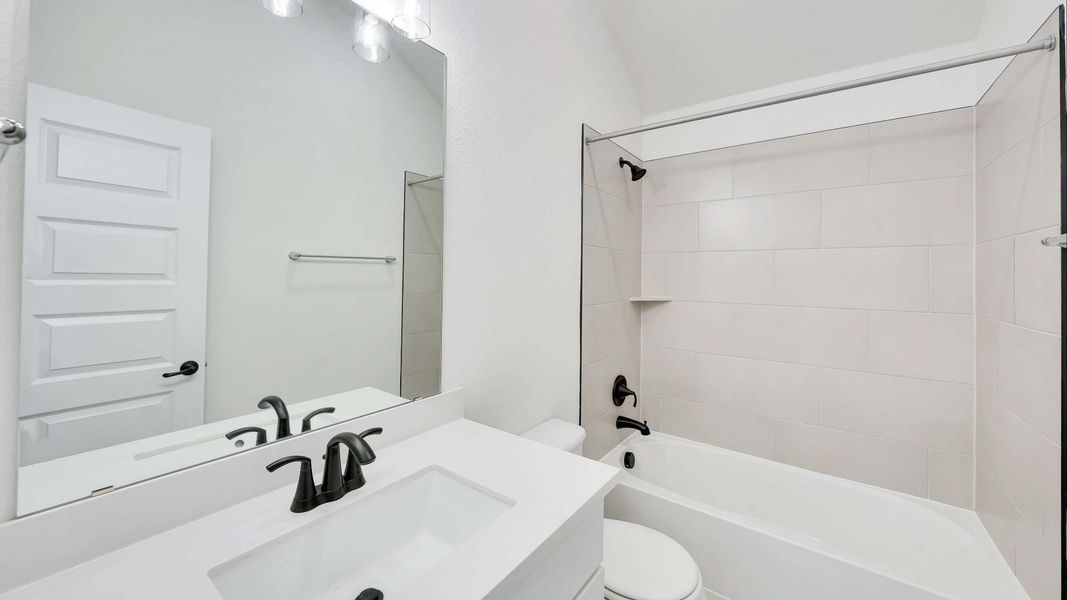 Representative furnished interior of a home built from the Palm by Brightland Homes in Sunterra, Katy (Image 13).