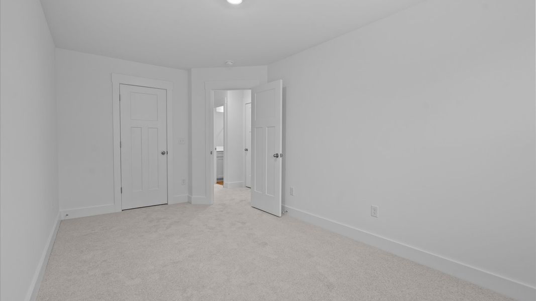 First-class secondary bedroom with comfortable carpeted flooring and generous closet space First-class secondary bedroom with comfortable carpeted flooring and generous closet space