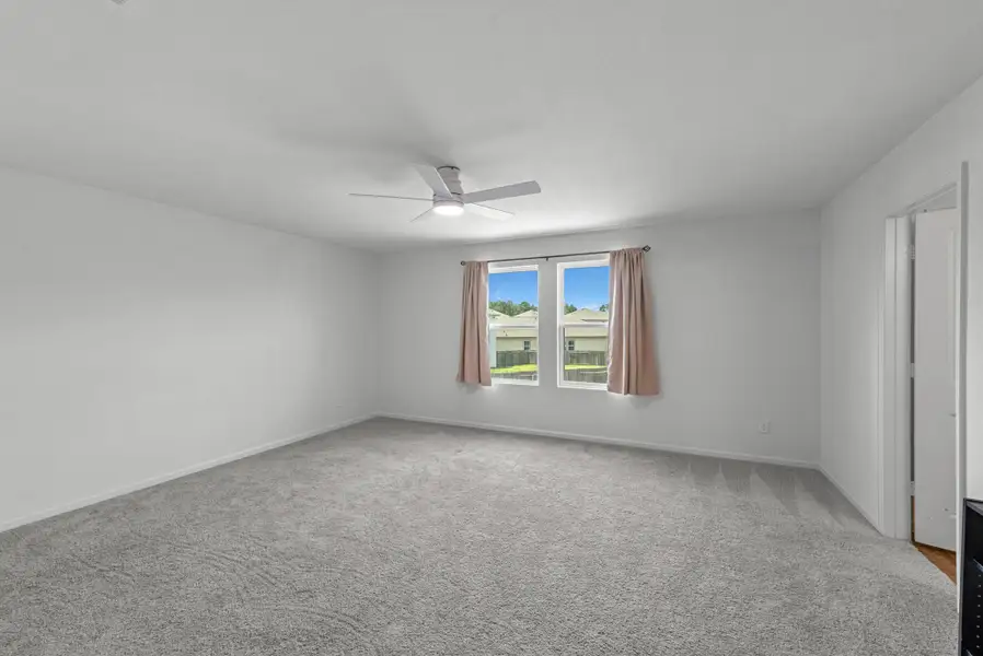 Reverse view of the primary bedroom.  Views to the large back yard