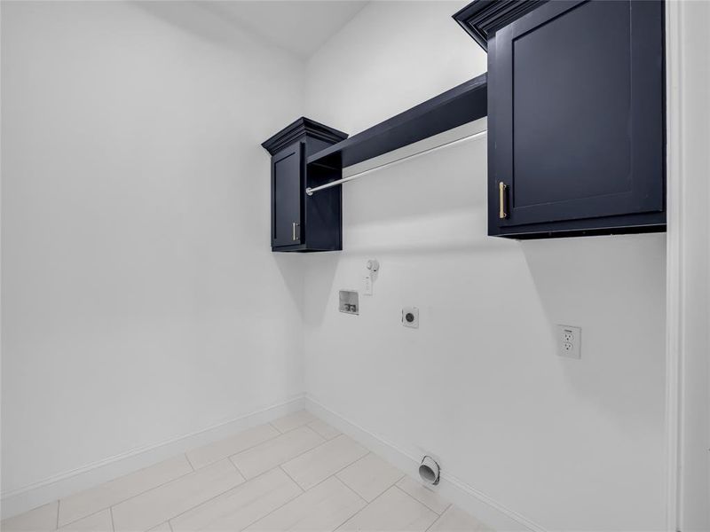 Washroom with hookup for an electric dryer, hookup for a washing machine, and cabinet space Washroom with hookup for an electric dryer, hookup for a washing machine, and cabinet space