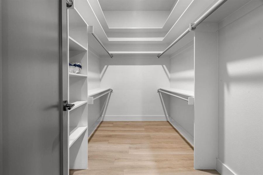 Walk in closet featuring light wood-style flooring