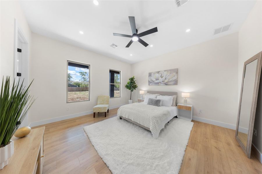 Bedroom featuring light wood-style flooring, ceiling fan, and recessed lighting Bedroom featuring light wood-style flooring, ceiling fan, and recessed lighting