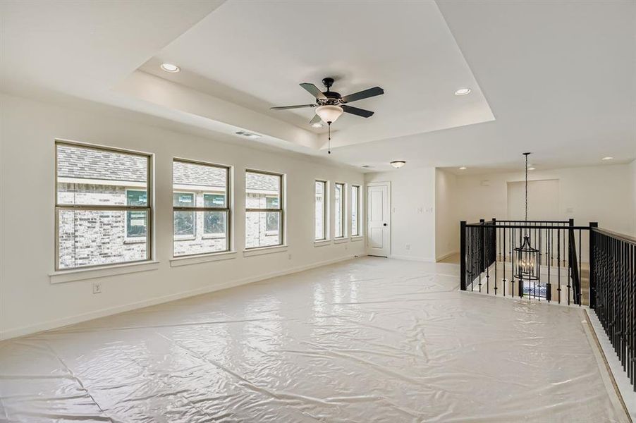 Unfurnished room featuring a raised ceiling, recessed lighting, and ceiling fan Unfurnished room featuring a raised ceiling, recessed lighting, and ceiling fan