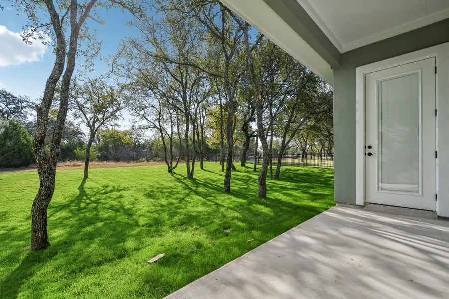 View of green lawn with a patio
