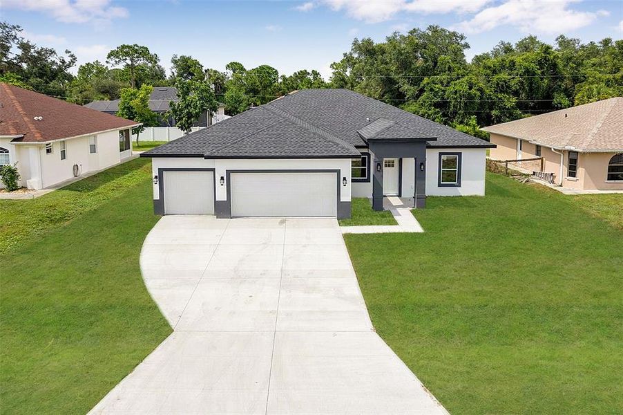 Front exterior of a new home in , North Port, FL, highlighting curb appeal (Image 22). Front exterior of a new home in , North Port, FL, highlighting curb appeal (Image 22).