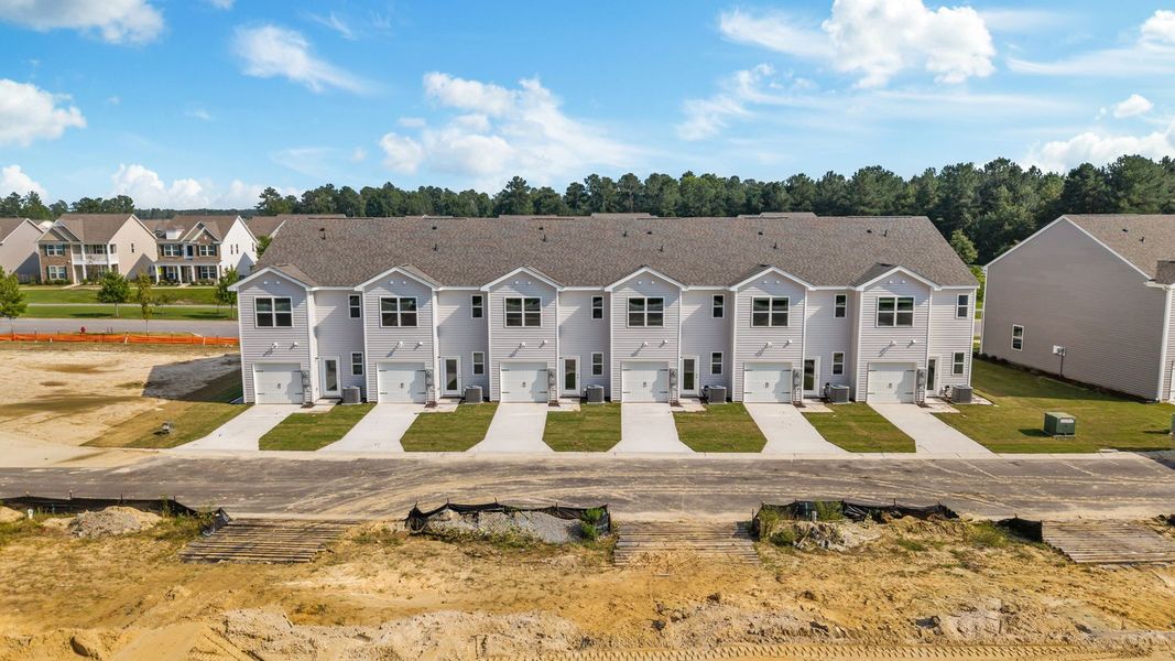 Front exterior of a new home in Clock Road Townhomes, New Bern, NC, highlighting curb appeal (Image 2). Front exterior of a new home in Clock Road Townhomes, New Bern, NC, highlighting curb appeal (Image 2).