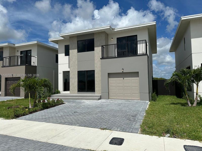 Front exterior of a new home in , Florida City, FL, highlighting curb appeal (Image 1). Front exterior of a new home in , Florida City, FL, highlighting curb appeal (Image 1).