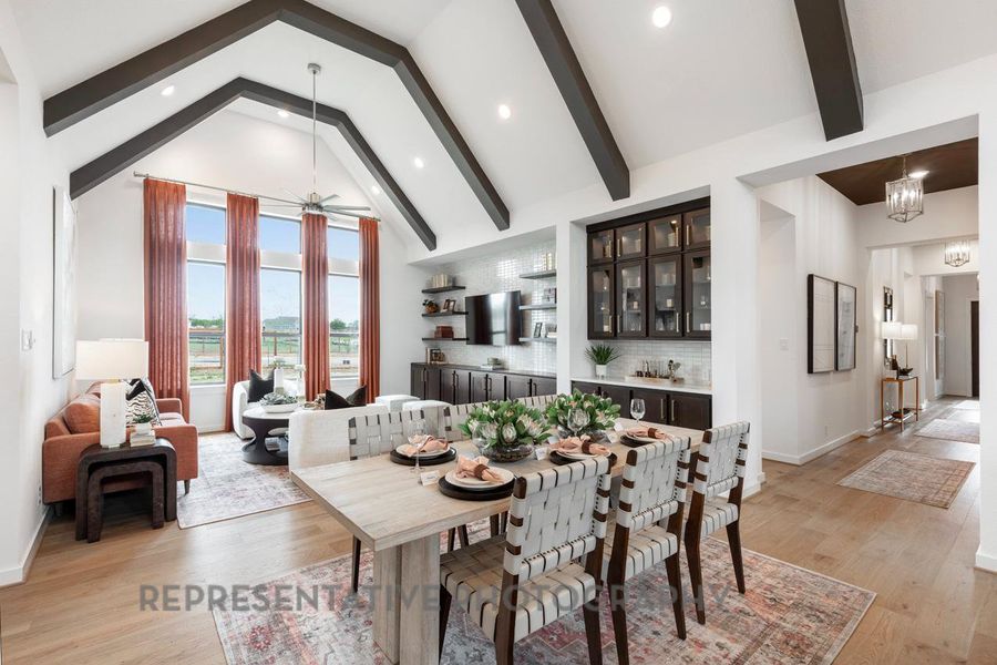 Dining room with beamed ceiling, light wood-type flooring, a chandelier, recessed lighting, and ceiling fan