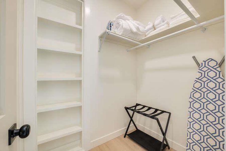 Spacious closet with light wood finished floors