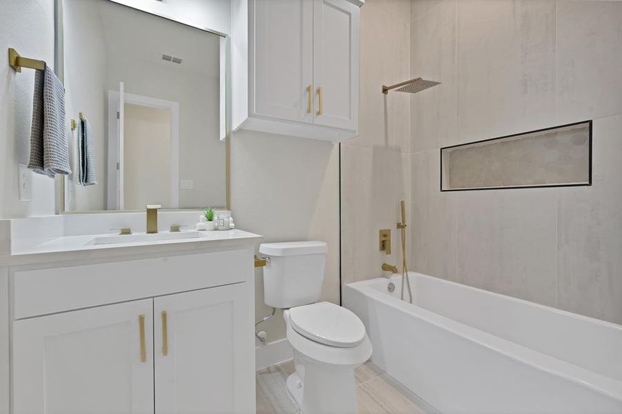 Full bath with toilet, vanity, and shower combination Full bath with toilet, vanity, and shower combination