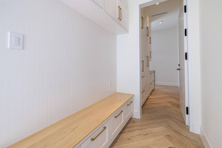 Mud room and pantry with built-in bench seating and storage. Mud room and pantry with built-in bench seating and storage.