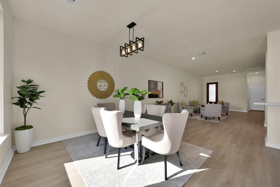 Dining area is also open to the living space and features a large window for plenty of natural light.