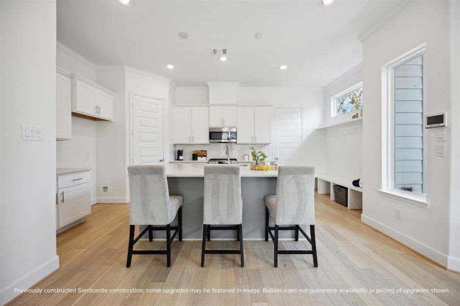 Culinary Excellence: Centered around a generous kitchen island, this modern chef's paradise boasts the latest in sleek stainless steel appliances from LG, marrying function with sophistication.