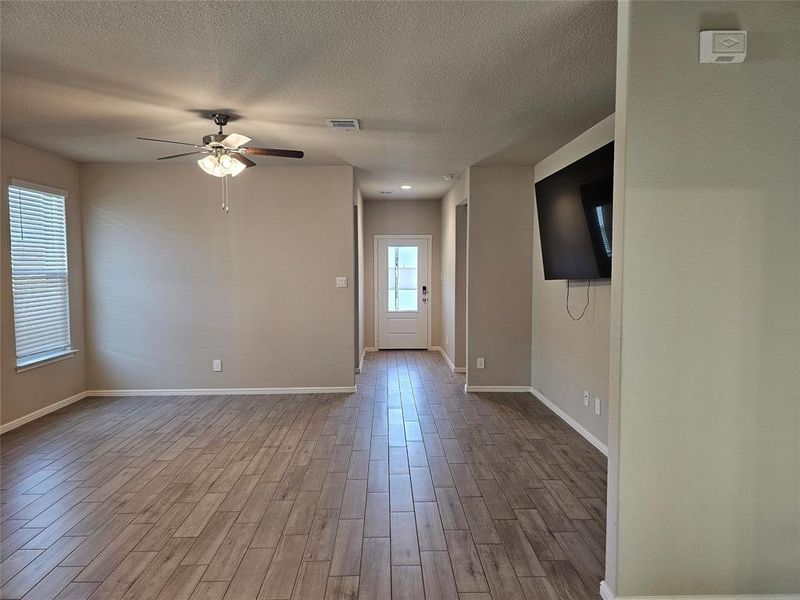 Entry and living room area featuring wood looking tile tile floors.