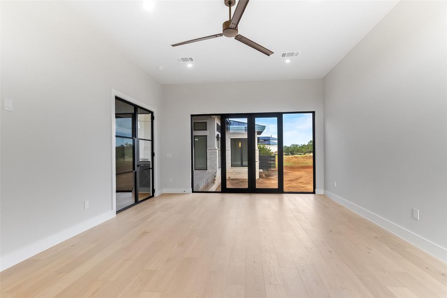 Spare room featuring ceiling fan, recessed lighting, light wood-style floors, and baseboards Spare room featuring ceiling fan, recessed lighting, light wood-style floors, and baseboards