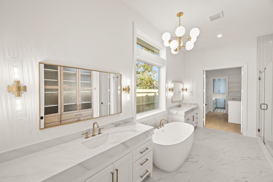 Dual vanities, soaker tub, walk-in shower, and private toilet closet!