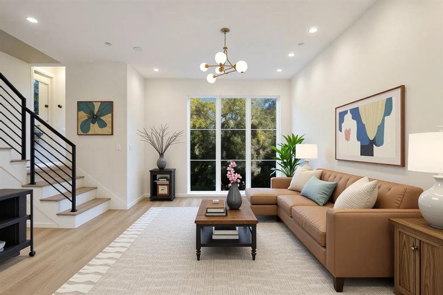 Living room featuring light wood-style flooring and suspended lighting