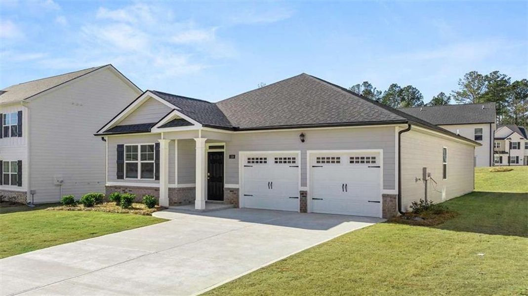 Front exterior of a new home in Oakchase at Hampton, Hampton, GA, highlighting curb appeal (Image 24).
