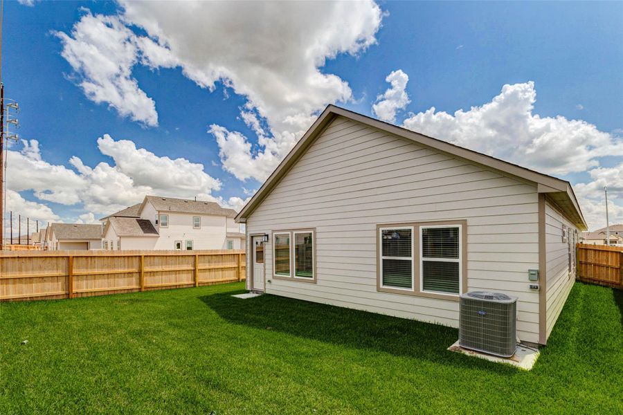 This backyard angle highlights the generous fenced yard, well-kept grass, rear exterior, and open sky above. With plenty of usable outdoor space, the yard is ready for simple relaxation, entertaining, or future personalization, while the full fence adds privacy and a clean finished look. This backyard angle highlights the generous fenced yard, well-kept grass, rear exterior, and open sky above. With plenty of usable outdoor space, the yard is ready for simple relaxation, entertaining, or future personalization, while the full fence adds privacy and a clean finished look.