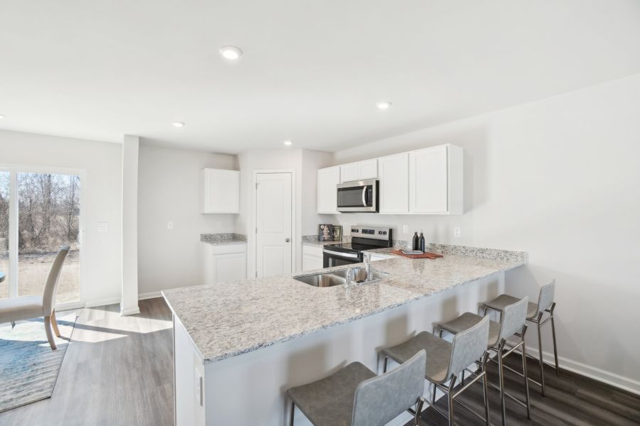 A kitchen with a marble island.