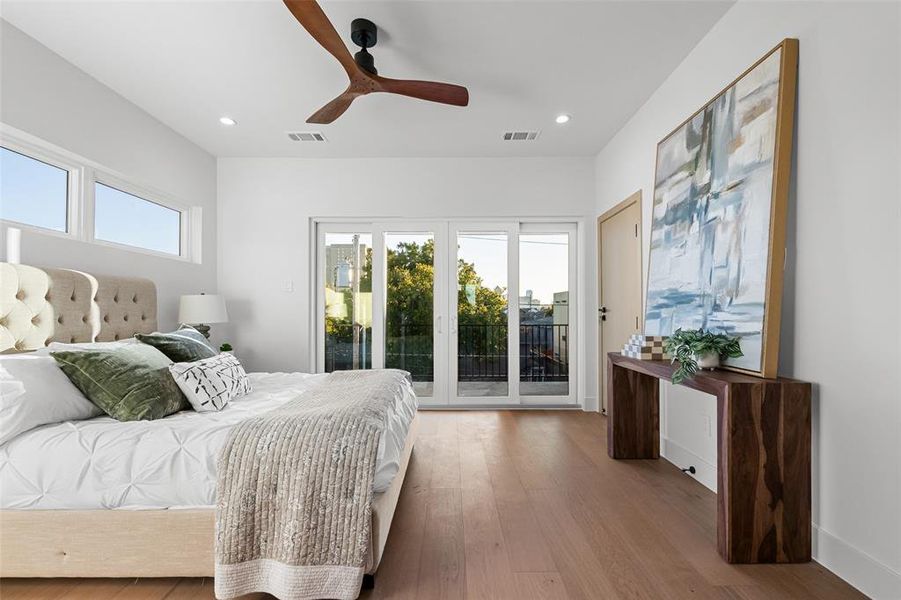Bedroom with multiple windows, hardwood / wood-style flooring, access to outside, ceiling fan, and recessed lighting