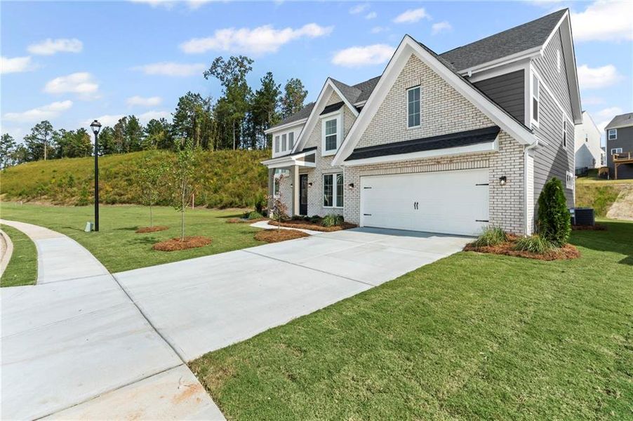 Front exterior of a new home in Twin Lakes, Hoschton, GA, highlighting curb appeal (Image 19).
