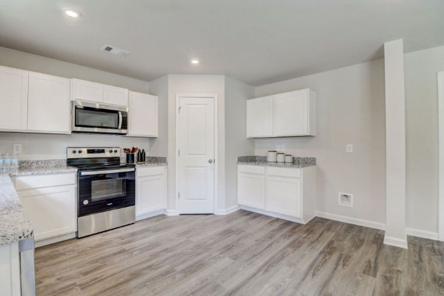 A kitchen with white cabinets. A kitchen with white cabinets.
