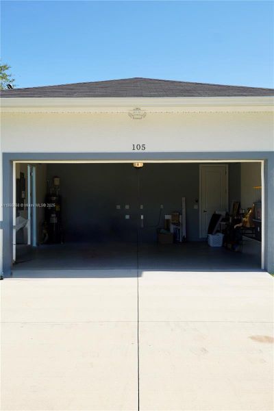 Front exterior of a new home in , Lehigh Acres, FL, highlighting curb appeal (Image 35).