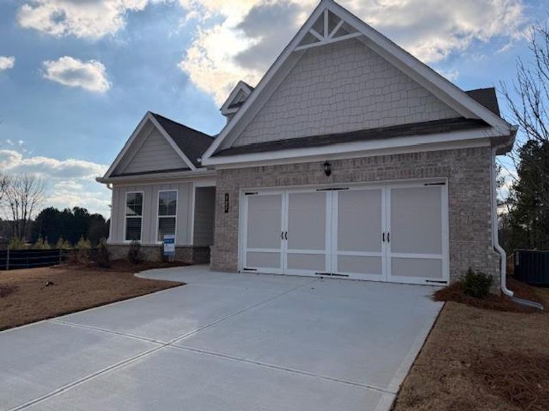 Front exterior of a new home in Cooper's Walk, Loganville, GA, highlighting curb appeal (Image 1). Front exterior of a new home in Cooper's Walk, Loganville, GA, highlighting curb appeal (Image 1).