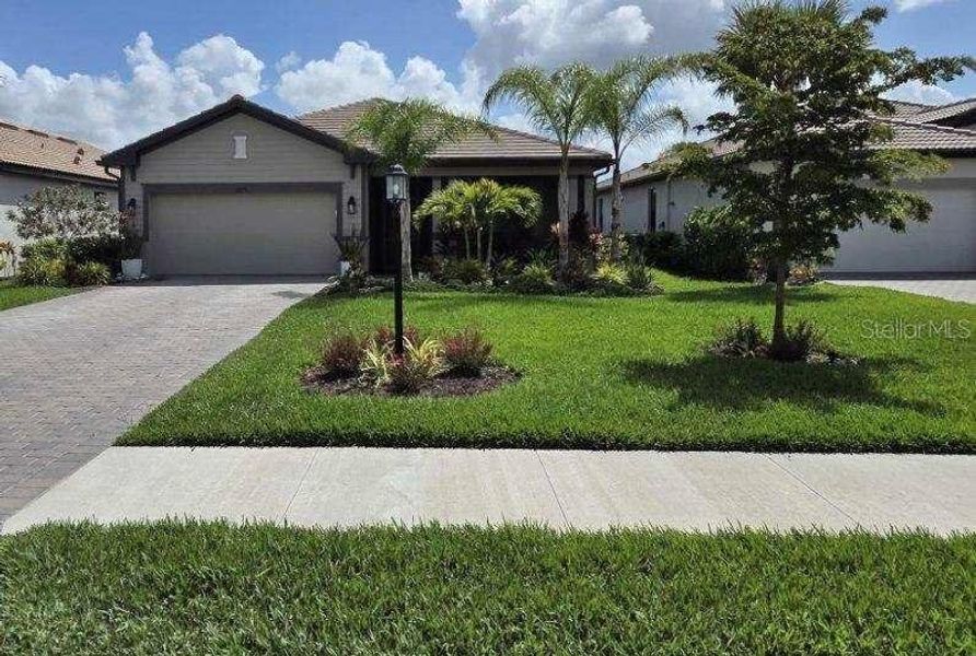 Front exterior of a new home in , Estero, FL, highlighting curb appeal (Image 24).