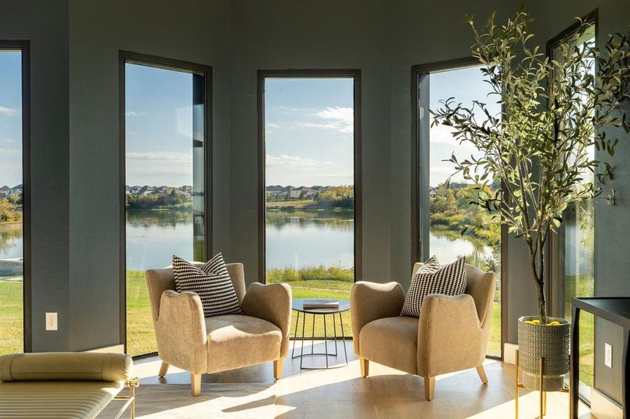 Sunroom / solarium featuring a water view and a wealth of natural light