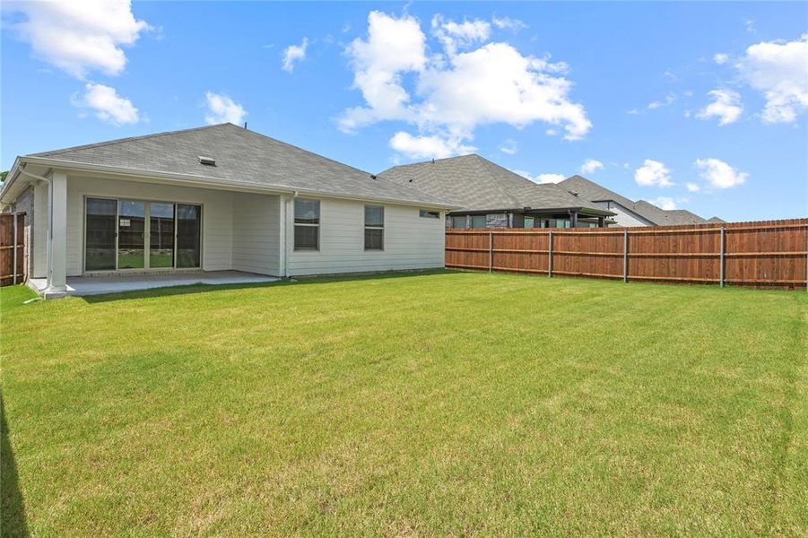 Rear view of house featuring a fenced backyard, a patio, and roof with shingles Rear view of house featuring a fenced backyard, a patio, and roof with shingles