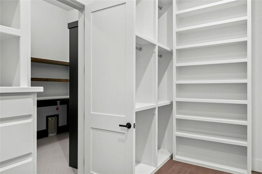 Spacious closet featuring dark wood-type flooring Spacious closet featuring dark wood-type flooring