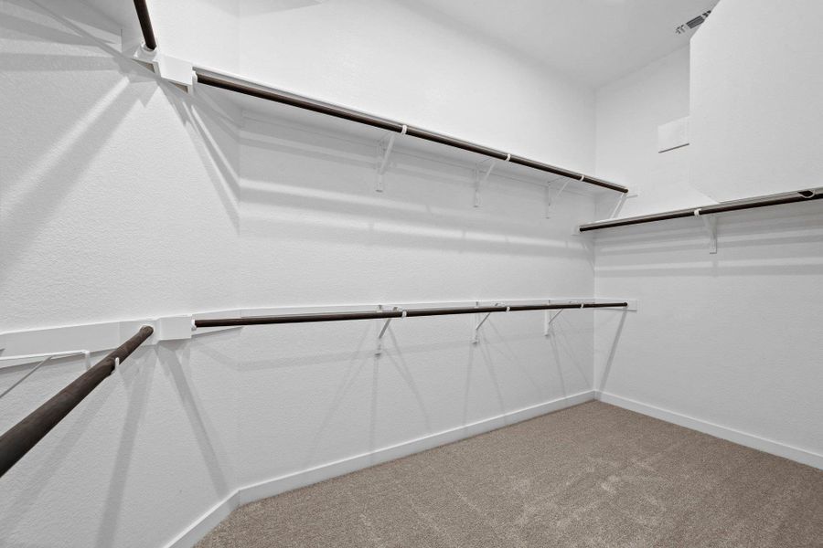 Walk-in closet in Primary Bedroom Walk-in closet in Primary Bedroom
